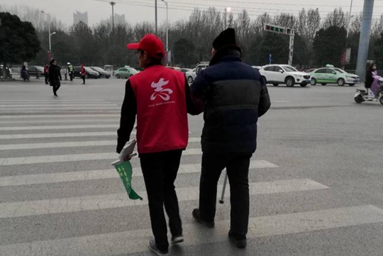 "爱我中牟文明出行"  志愿者搀扶老人过马路倡树文明榜样