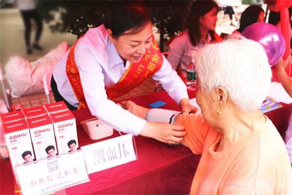 图为工作人员在为社区居民免费测量血压